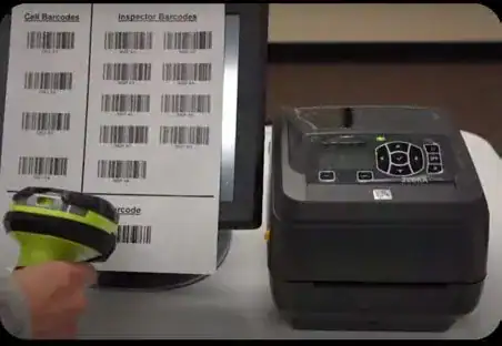 Hand scanning a sheet of barcodes with a handheld scanner next to a Zebra desktop printer