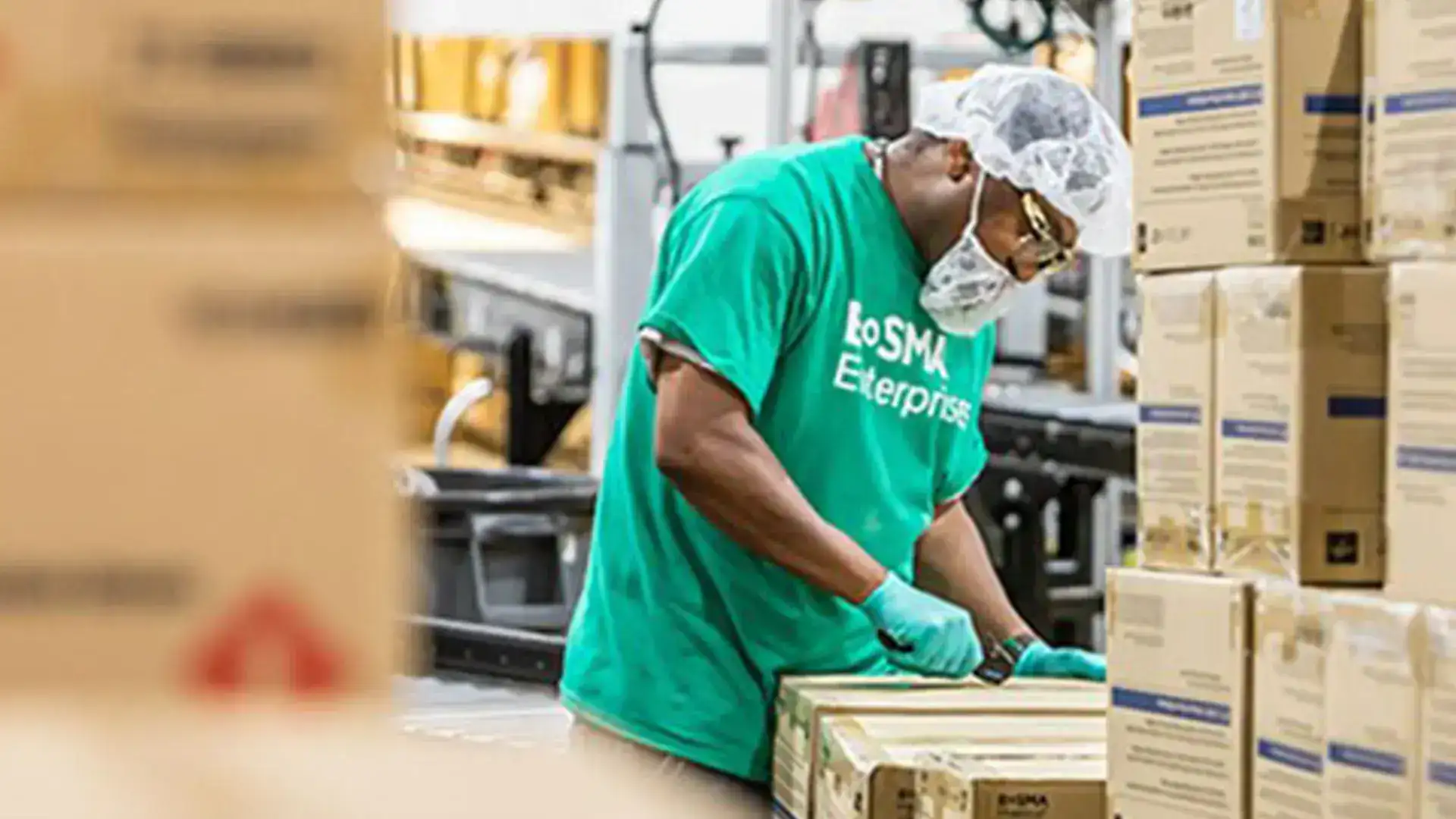 Bosma Enterprises Worker Opens Box