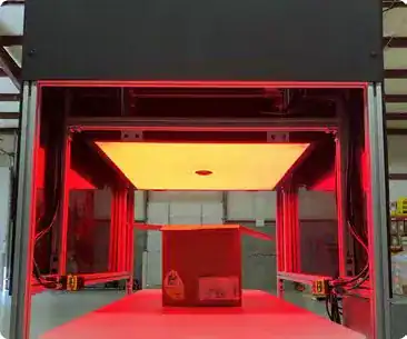 Vision inspection tunnel with a large overhead light illuminating a box of label stacks in red