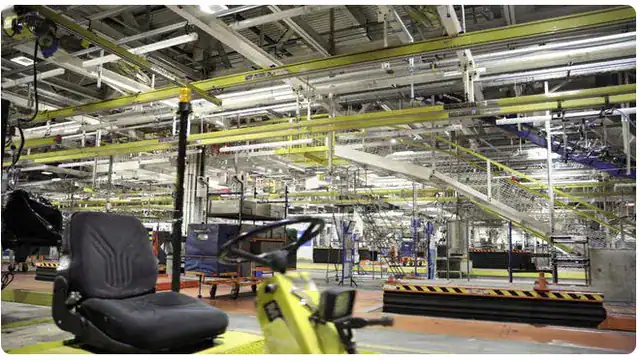 Automotive assembly plant floor with overhead conveyors