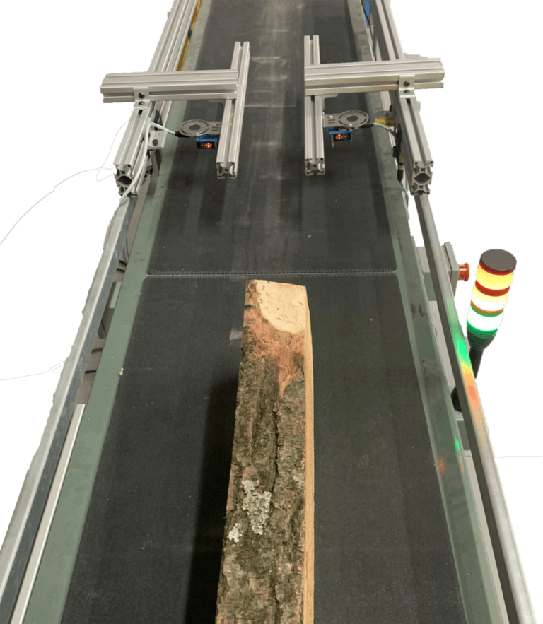 Log on conveyor passing through laser measurement system