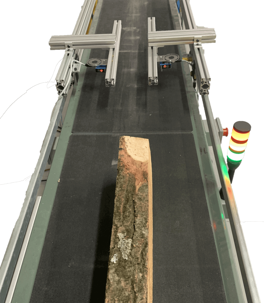 Log on conveyor passing through laser measurement system