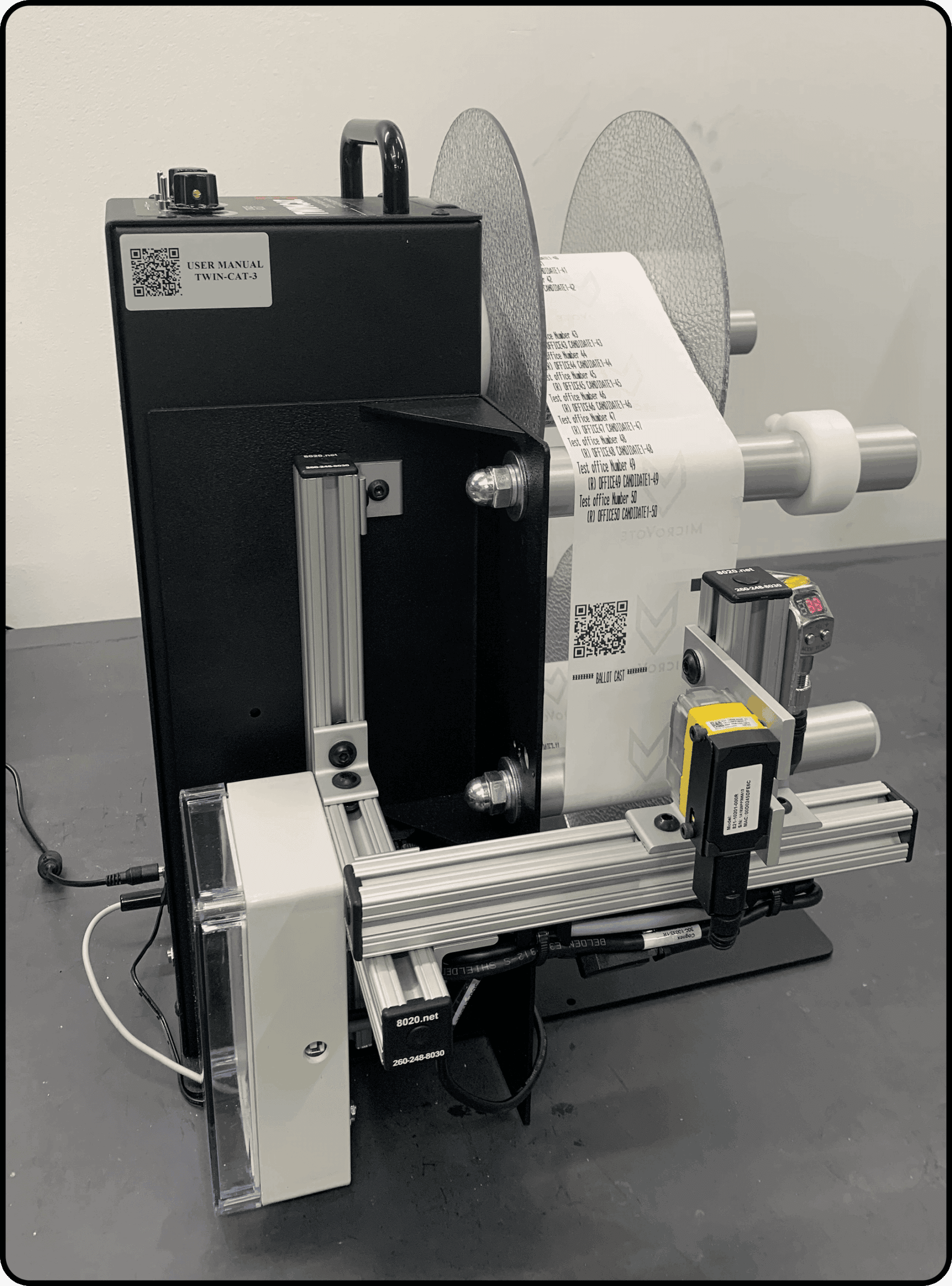 Ballot verification station with a Twin Cat label printer, barcode reader, and paper roll