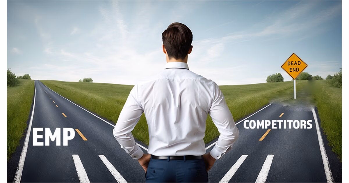 Man standing at a fork in the road between a lane marked EMP and a dead-end lane marked Competitors