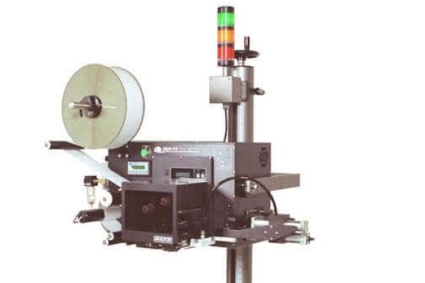 Label print and apply system on a stand with a label roll and a stack light