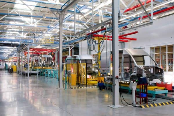 Automotive assembly line with van body shells on an overhead conveyor