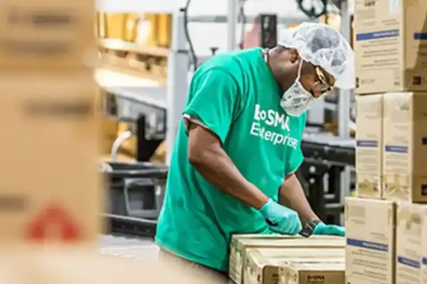 Bosma Enterprises Worker Opens Box
