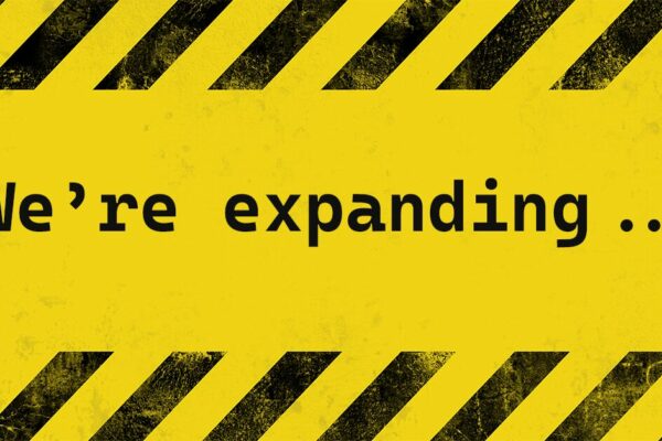 Caution tape stating "We're Expanding"