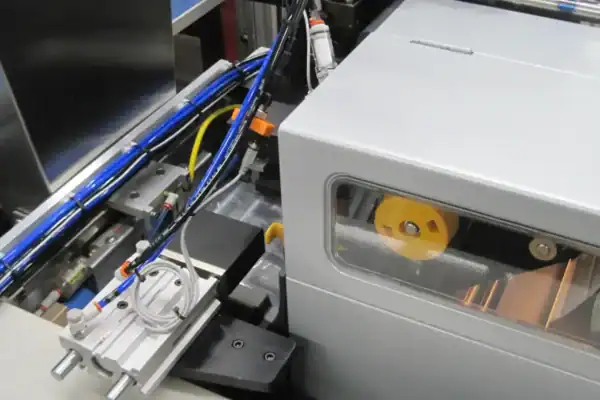 Robotic cell with a label printer applicator and blue pneumatic tubing