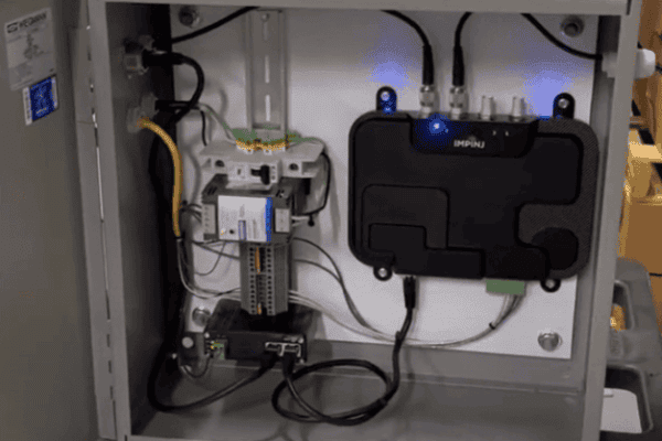 Open control enclosure with a Zebra fixed RFID reader, power supply, and wiring